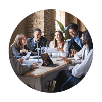 A Group Of People Sitting At A Table